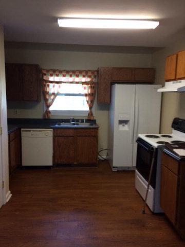 500 Huckabee Road Gray, GA 31032 - Photo 10 of 17 a kitchen with granite countertop a stove and a refrigerator