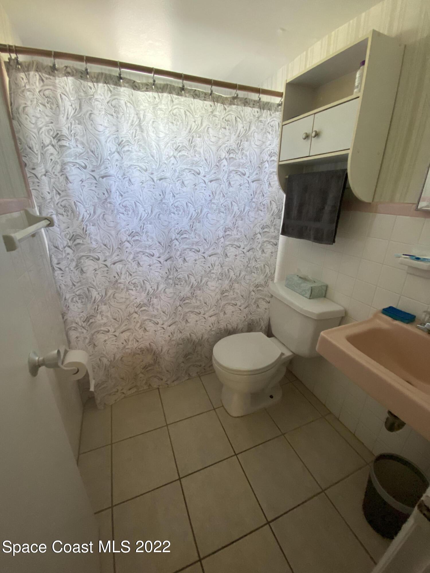 610 Jefferson Avenue, Unit 2 Cape Canaveral, FL 32920 - Photo 7 of 8 a bathroom with a toilet and a shower