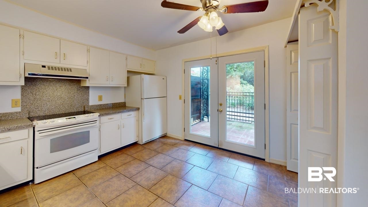 4009 Old Shell Road, Unit C13 Mobile, AL 36608 - Photo 9 of 32 Kitchen featuring white appliances, exhaust hood, decorative backsplash, ceiling fan, and baseboards