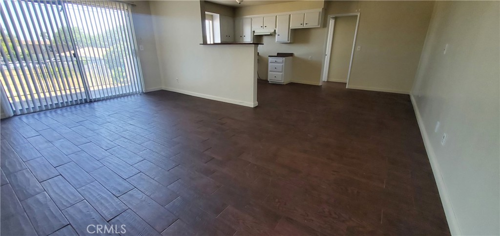 1815 Locust Avenue, Unit 8 Long Beach, CA 90806 - Photo 2 of 6 an empty room with wooden floor and windows