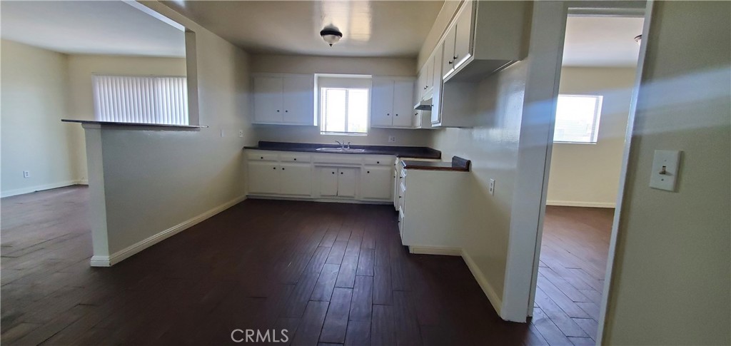 1815 Locust Avenue, Unit 8 Long Beach, CA 90806 - Photo 3 of 6 a kitchen with a sink and wooden floor