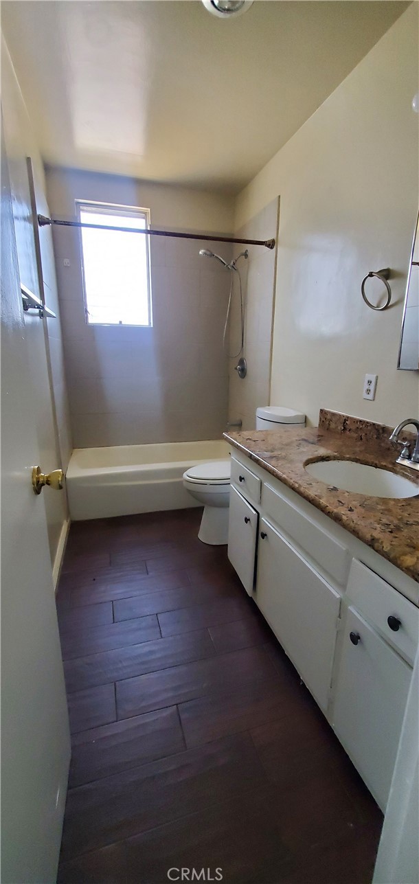 1815 Locust Avenue, Unit 8 Long Beach, CA 90806 - Photo 6 of 6 a bathroom with a granite countertop sink a toilet and bathtub