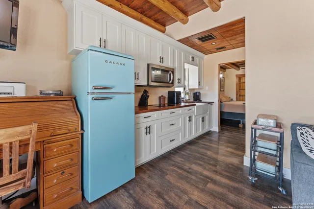 a kitchen with stainless steel appliances a refrigerator and wooden cabinets