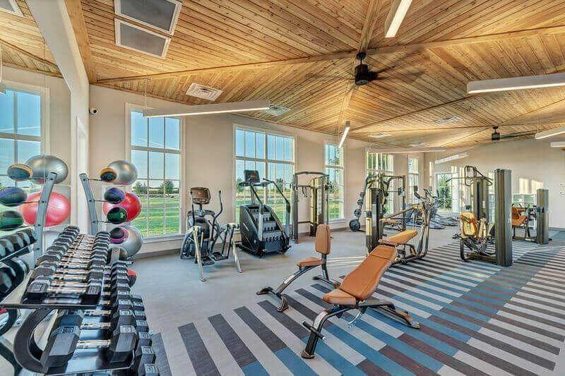 8408 Twistpine Road Frisco, TX 75035 - Photo 35 of 38 Fitness center featuring a vaulted wood-paneled ceiling, large windows, ceiling fans, and various exercise equipment