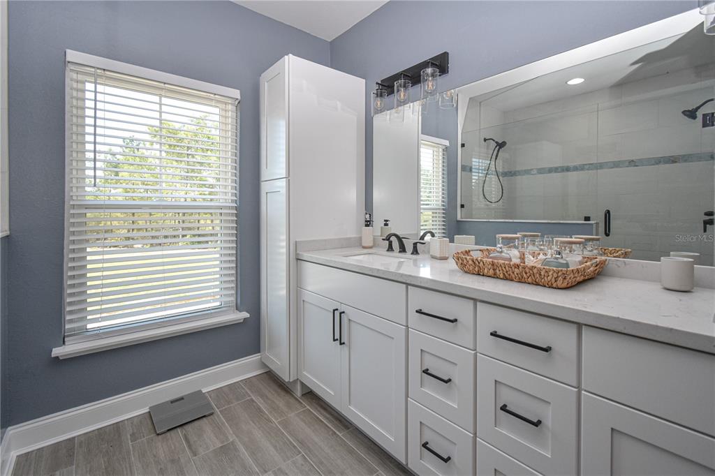 7890 Southwest 129th Avenue Cedar Key, FL 32625 - Photo 24 of 45 a bathroom with a granite countertop sink and a window
