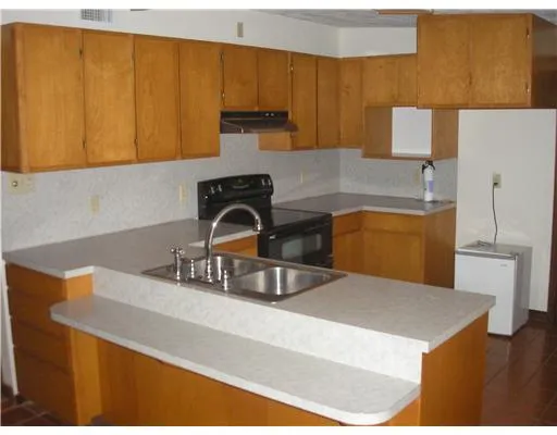 a kitchen with a sink a stove and a microwave