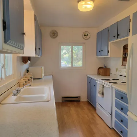 a kitchen with cabinets appliances and a window