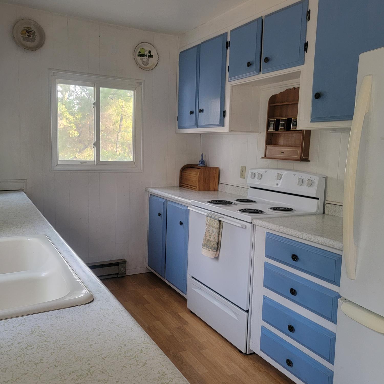 13021 Ridge View Drive Sutter Creek, CA 95685 - Photo 7 of 35 a kitchen with cabinets appliances and a window