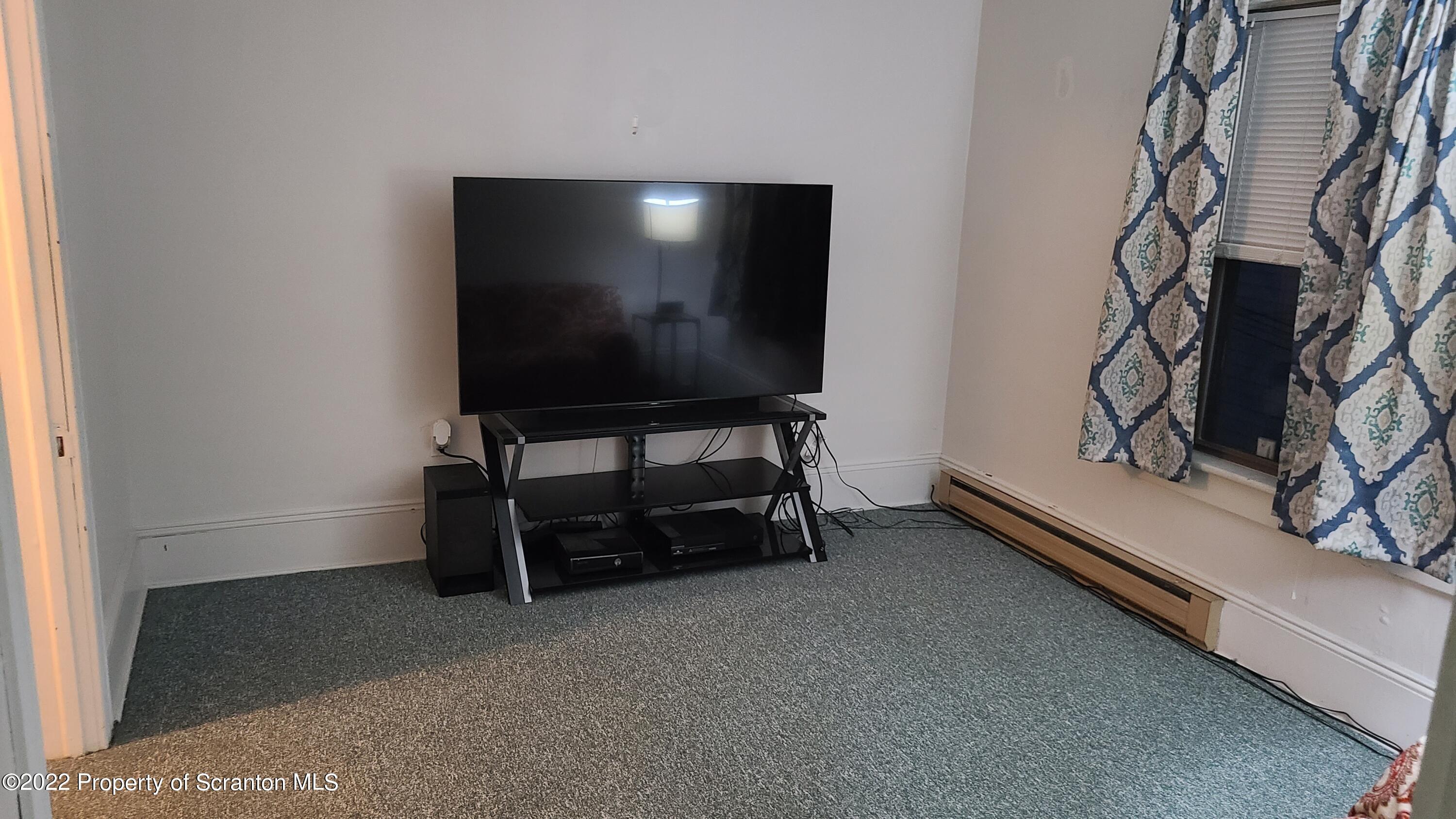 418 North Main Street Simpson, PA 18407 - Photo 19 of 19 a living room with furniture and a flat screen tv