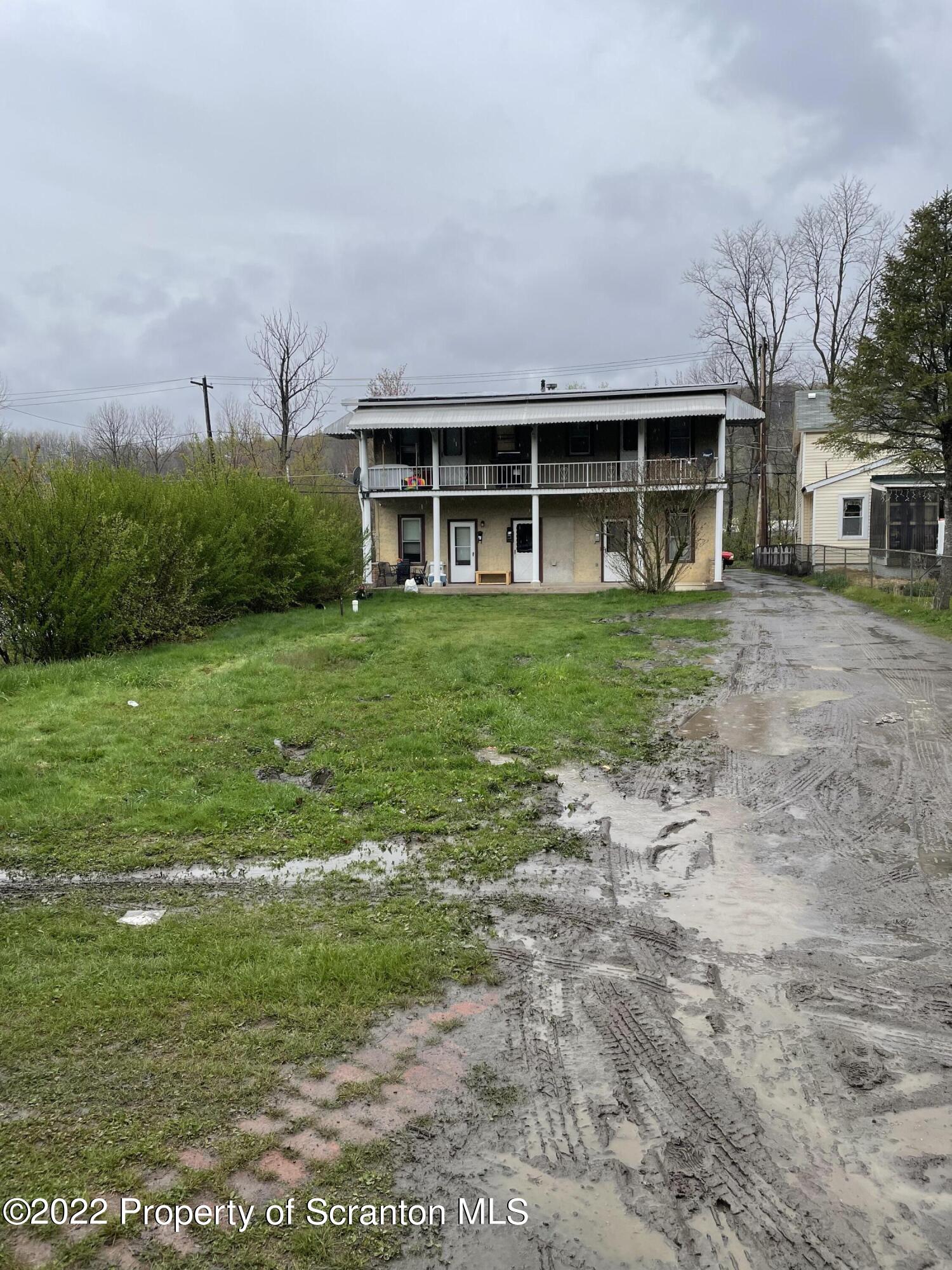 418 North Main Street Simpson, PA 18407 - Photo 6 of 19 a front view of a house with a garden