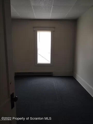 418 North Main Street Simpson, PA 18407 - Photo 10 of 19 an empty room with a window