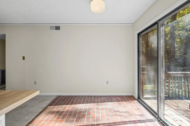 a view of a room with wooden floor and glass door