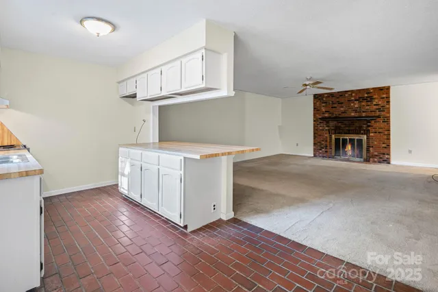 a view of a kitchen with furniture and a ceiling fan