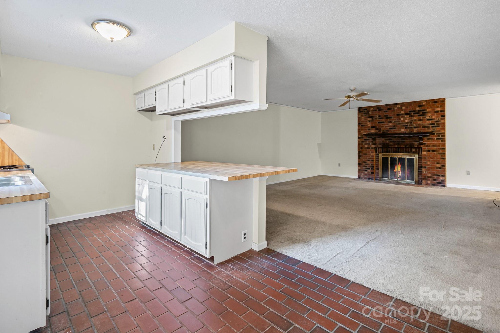 331 Meadowbrook Road Charlotte, NC 28211 - Photo 12 of 32 a view of a kitchen with furniture and a ceiling fan