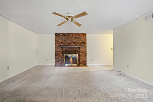 a view of an empty room with a fireplace