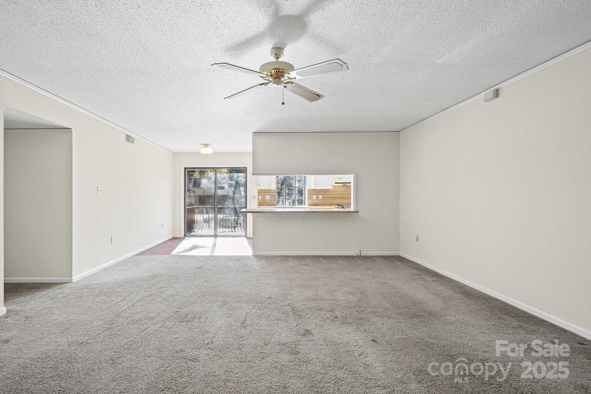 331 Meadowbrook Road Charlotte, NC 28211 - Photo 6 of 32 a view of a livingroom with a ceiling fan and window