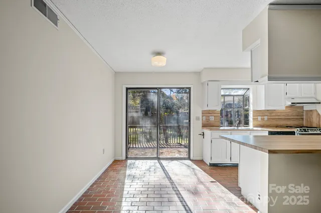 a kitchen with stainless steel appliances a refrigerator and a stove top oven