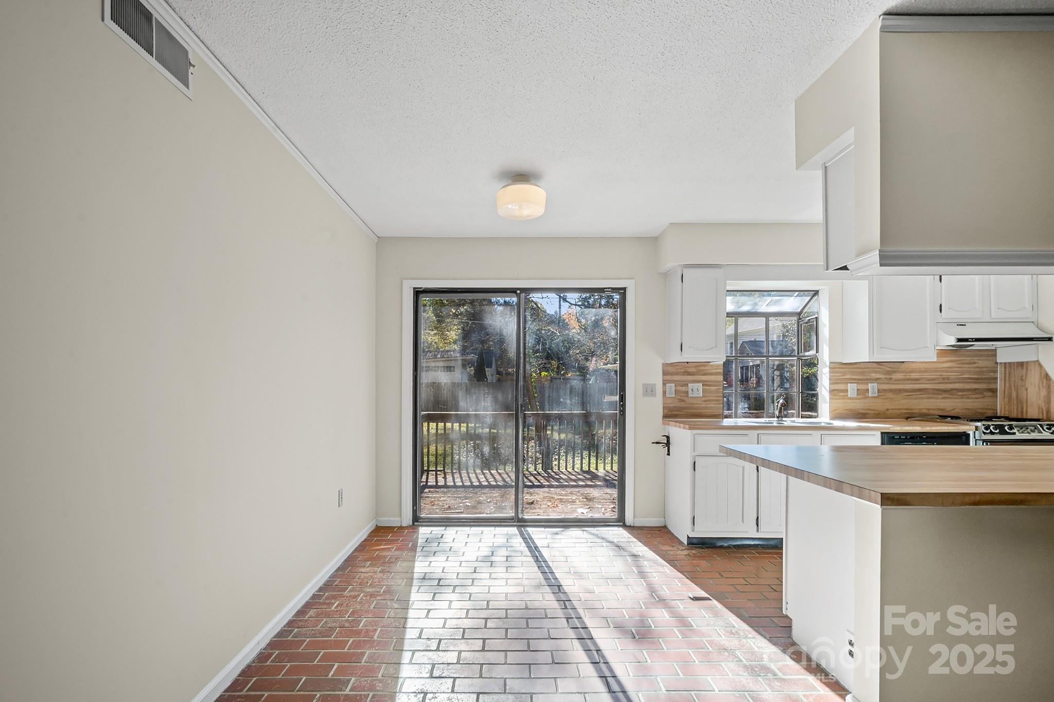 331 Meadowbrook Road Charlotte, NC 28211 - Photo 8 of 32 a kitchen with stainless steel appliances a refrigerator and a stove top oven