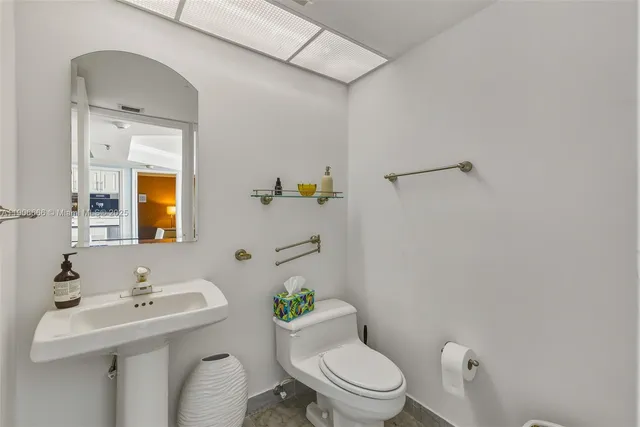 a bathroom with a sink mirror toilet and shower