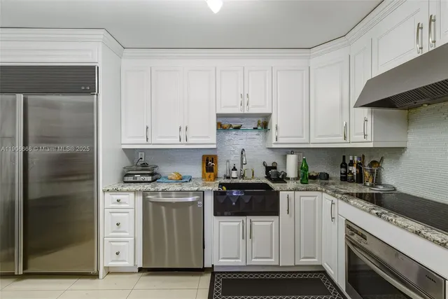 a kitchen with white cabinets and white appliances