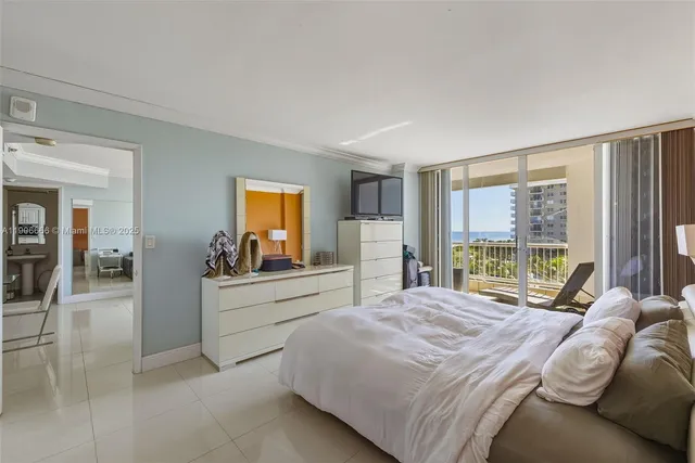 a large bedroom with a large bed and a large window