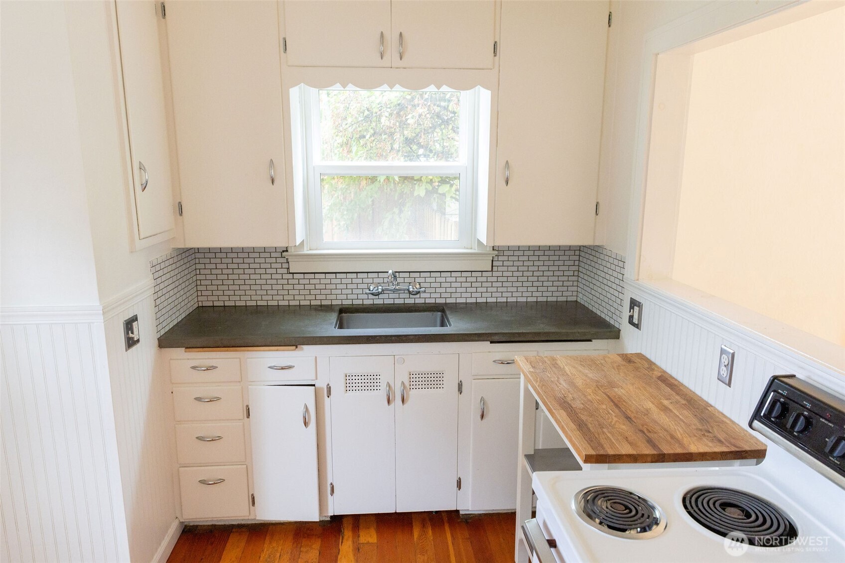 319 East Chestnut Street Walla Walla, WA 99362 - Photo 13 of 32 a kitchen with a sink a stove and cabinets