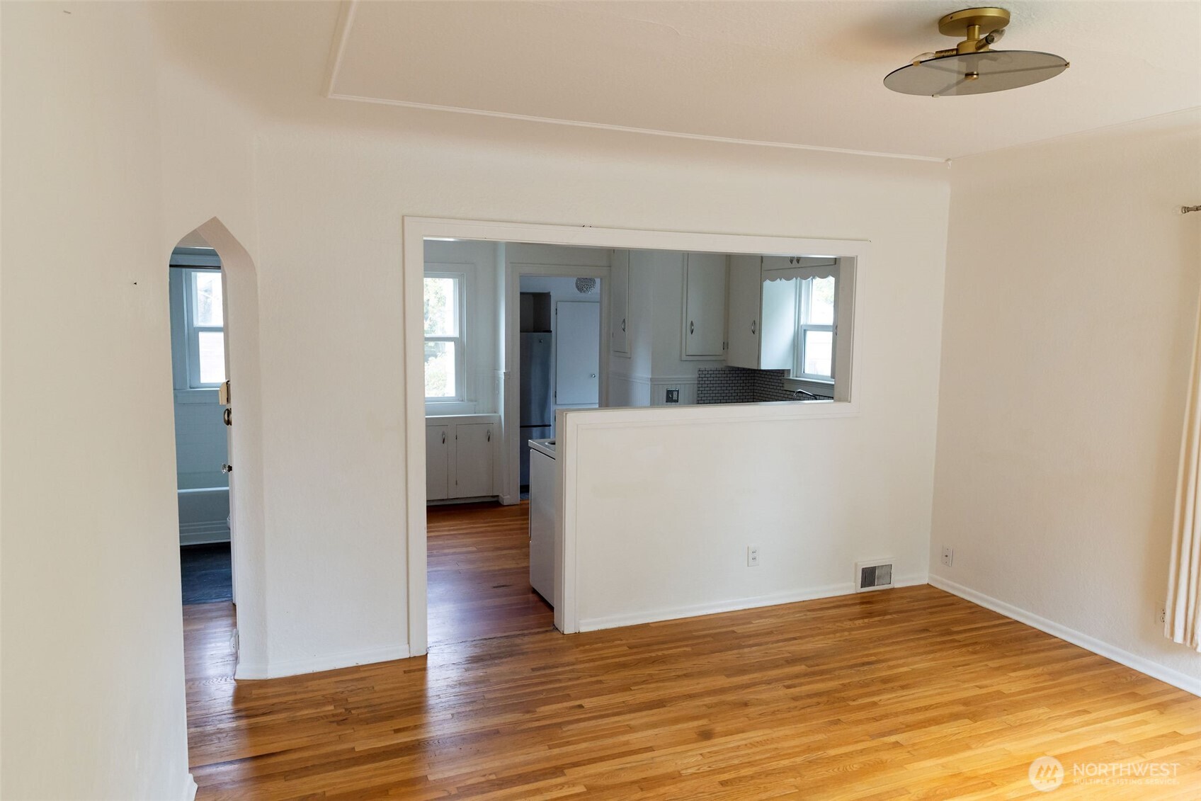 319 East Chestnut Street Walla Walla, WA 99362 - Photo 8 of 32 a view of a livingroom with a flesh screen tv and wooden floor