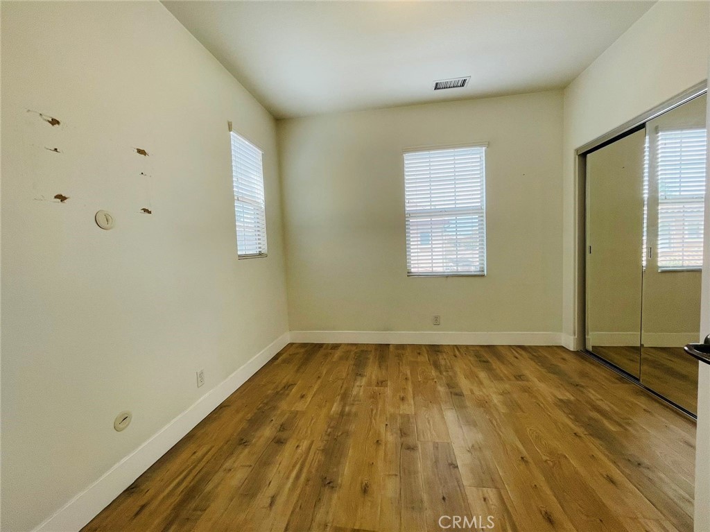 173 Sanctuary Irvine, CA 92620 - Photo 15 of 24 a view of a room with wooden floor and window