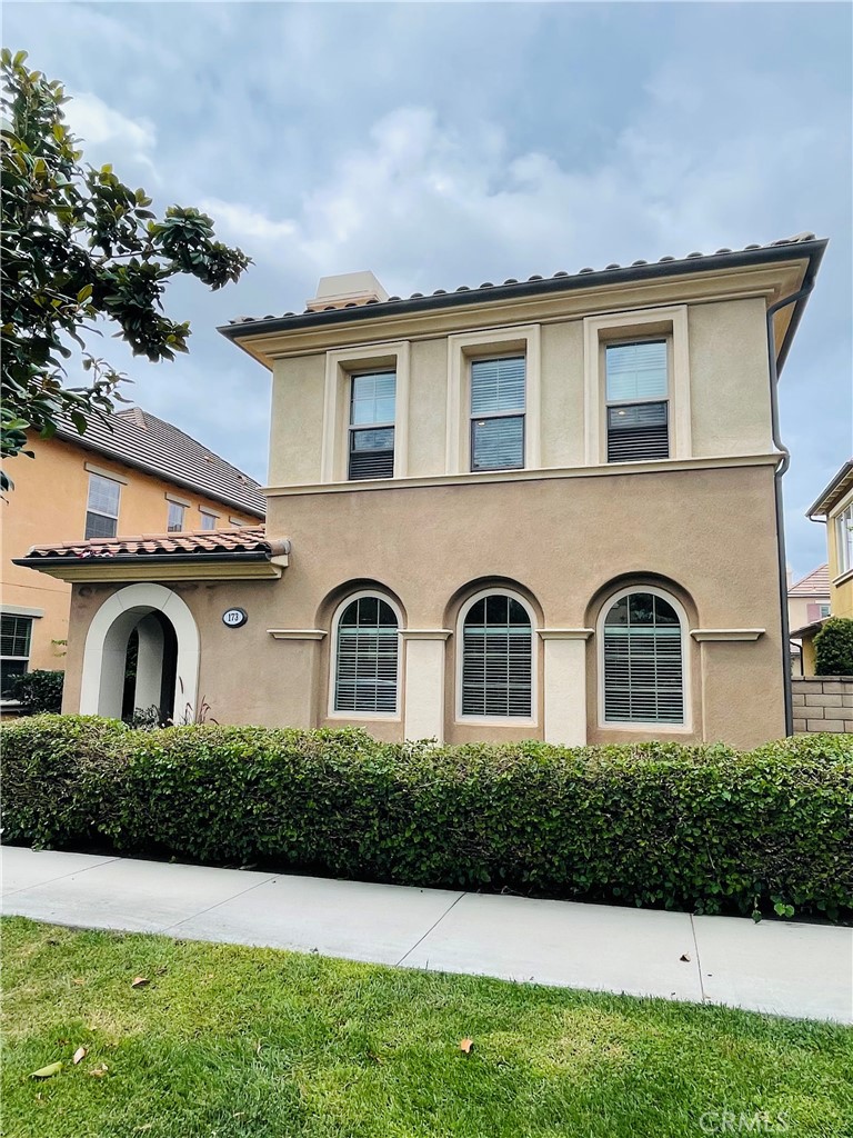173 Sanctuary Irvine, CA 92620 - Photo 2 of 24 a front view of a house with a yard