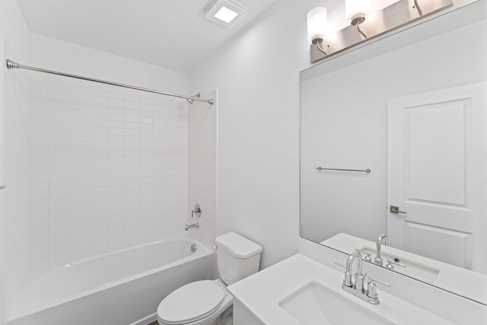 9740 Apollo Avenue, Unit 2 Fort Pierce, FL 34945 - Photo 12 of 18 a bathroom with a sink toilet and shower