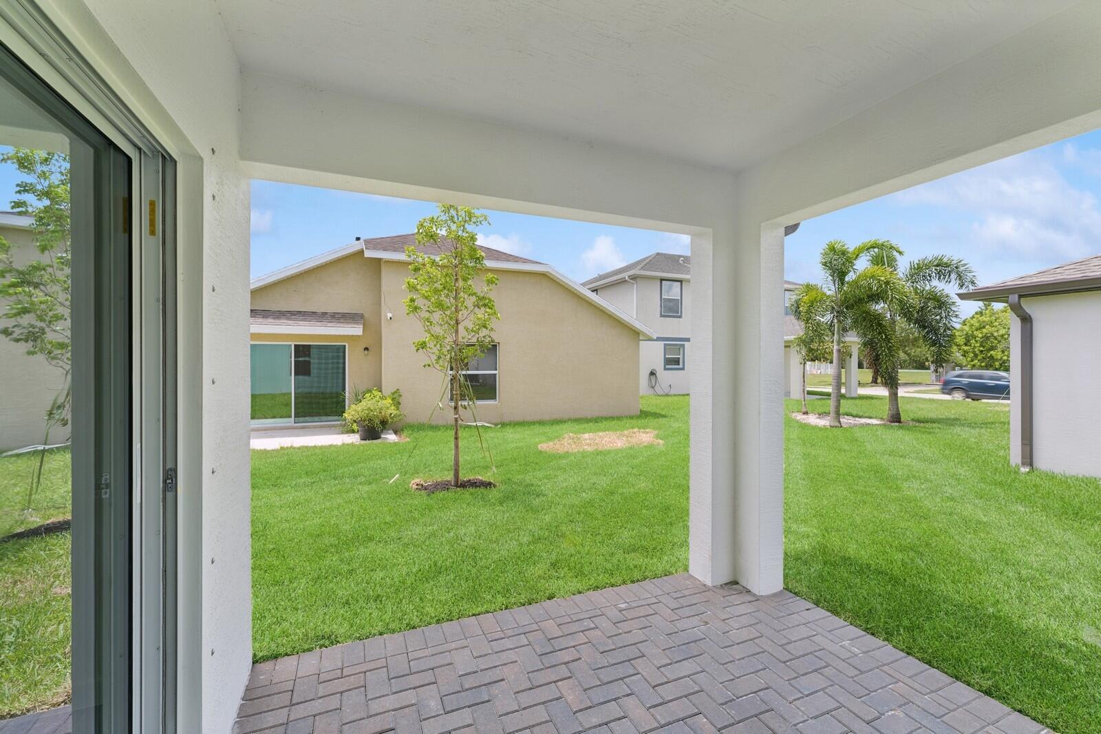 9740 Apollo Avenue, Unit 2 Fort Pierce, FL 34945 - Photo 15 of 18 a view of a house with a backyard