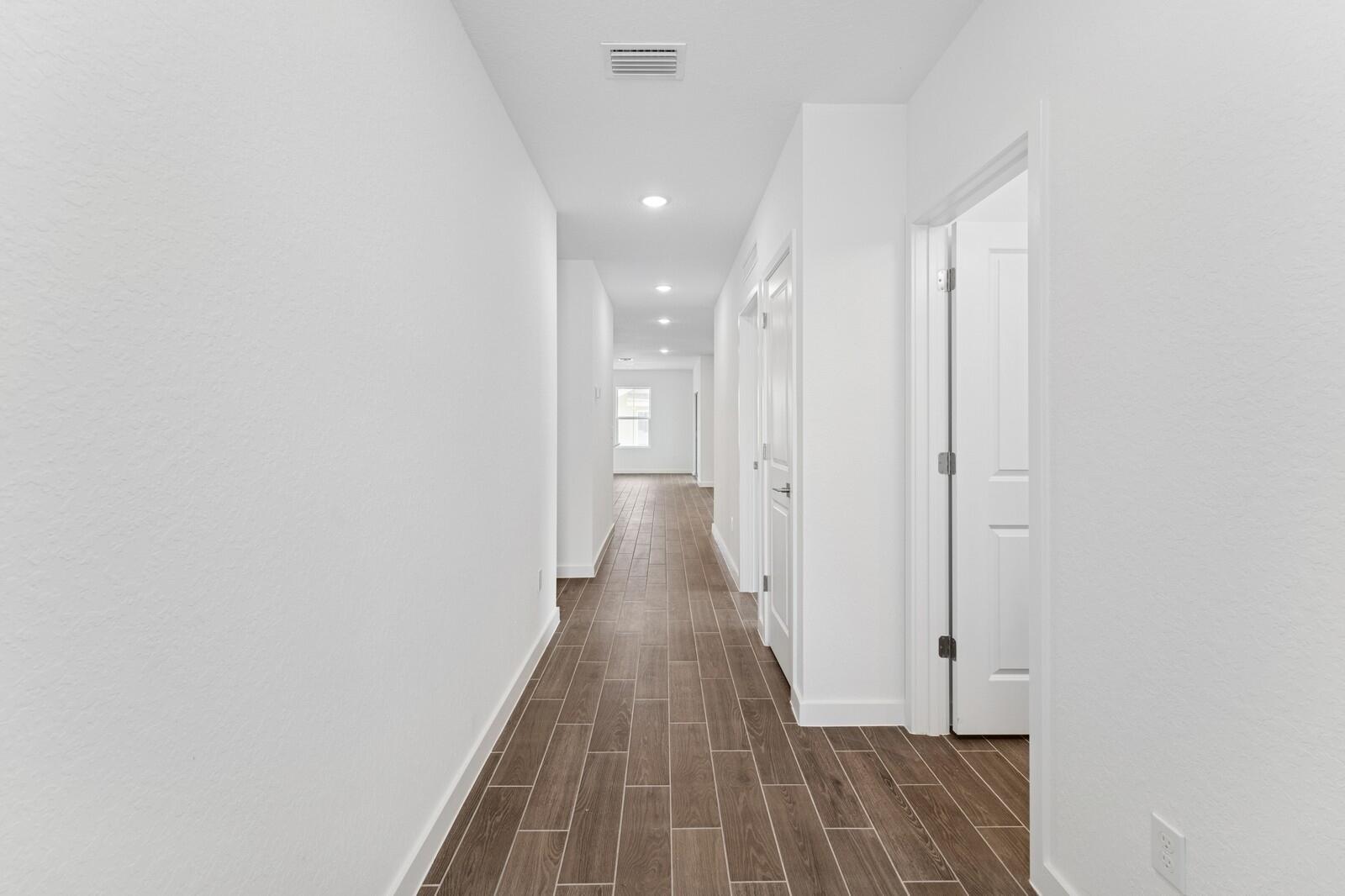 9740 Apollo Avenue, Unit 2 Fort Pierce, FL 34945 - Photo 2 of 18 a view of a hallway with wooden floor