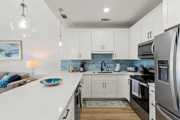 a kitchen with a sink a stove and cabinets