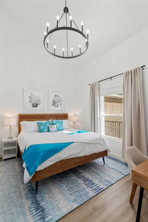 a bedroom with a bed and a chandelier