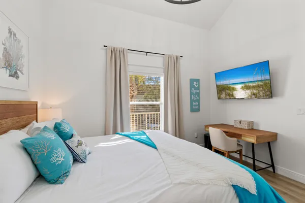 a bedroom with a bed and a chair