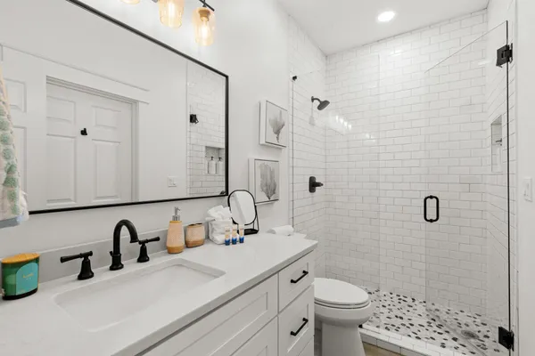 a bathroom with a sink toilet and shower