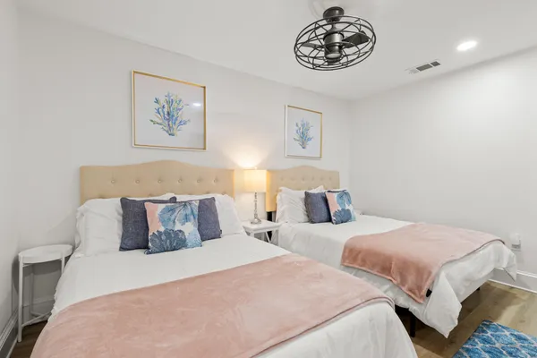 a bedroom with two beds and a table