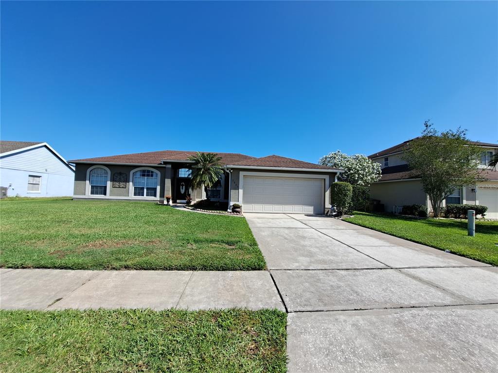 a front view of a house with a yard and garage