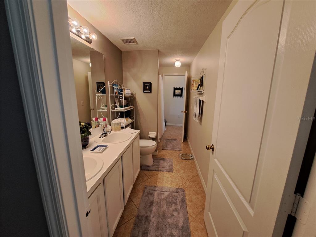 2863 Middleton Circle Kissimmee, FL 34743 - Photo 15 of 43 a kitchen with refrigerator a sink and wooden floor