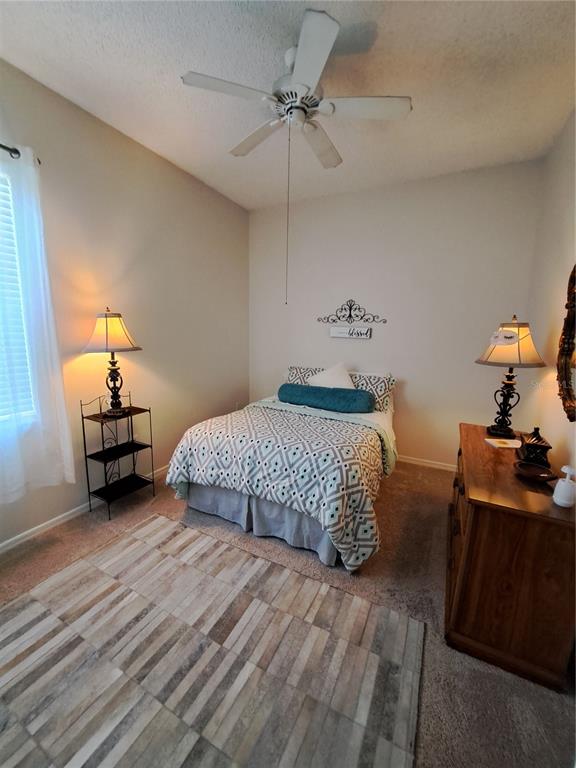 2863 Middleton Circle Kissimmee, FL 34743 - Photo 32 of 43 a bedroom with a bed and a lamp on table