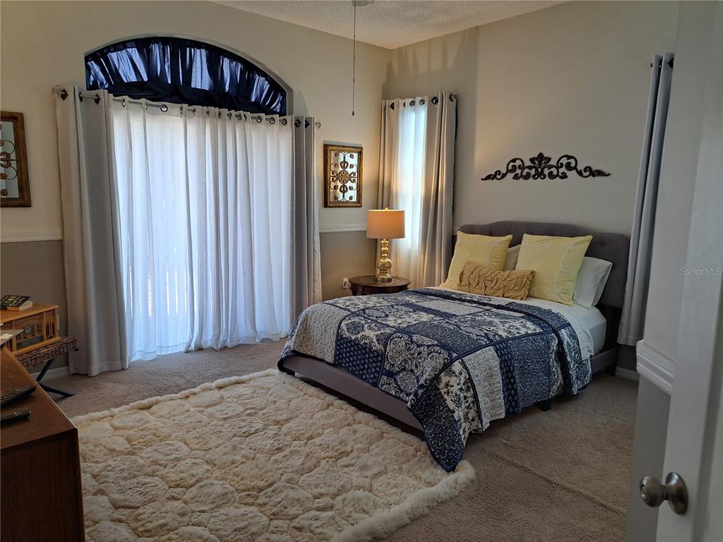 2863 Middleton Circle Kissimmee, FL 34743 - Photo 36 of 43 a bedroom with a bed and a dresser