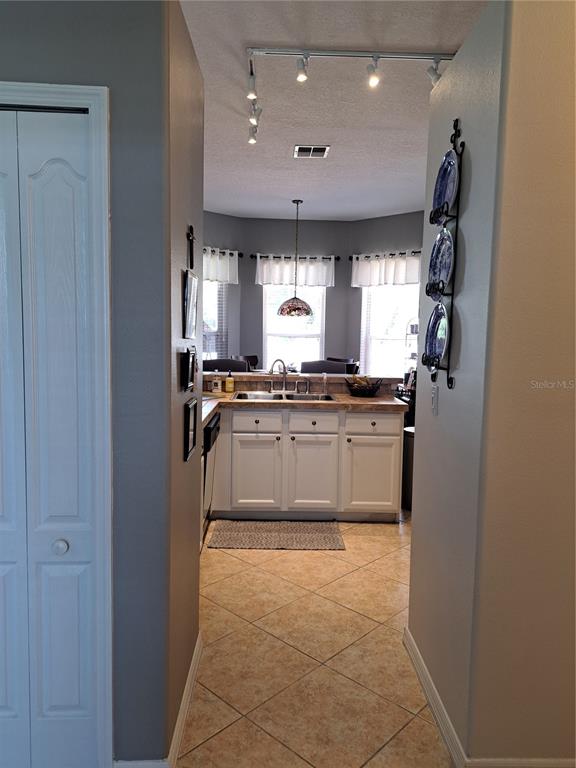 2863 Middleton Circle Kissimmee, FL 34743 - Photo 41 of 43 a kitchen with kitchen island granite countertop a stove a sink and a refrigerator