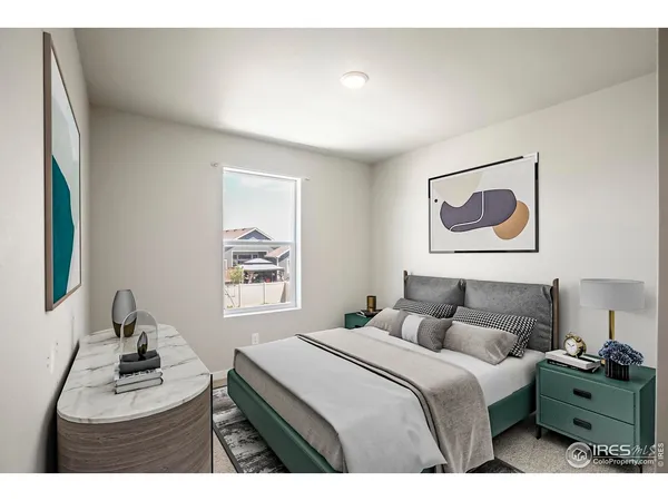 a bedroom with a bed and painting on the wall