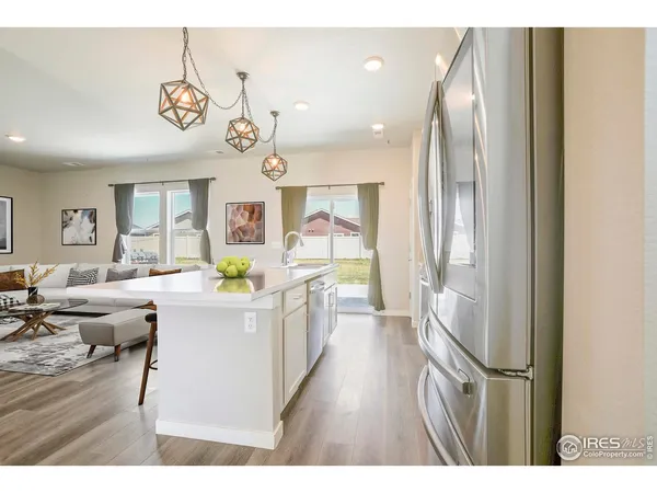 a very nice looking dining room with a large window and wooden floor