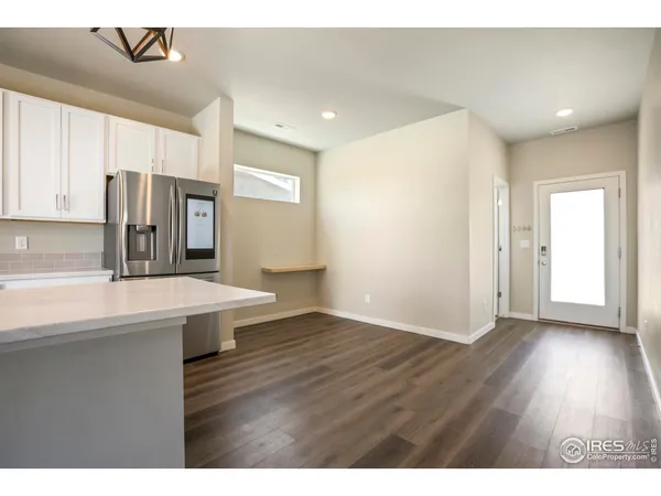 a view of a kitchen with a sink and a refrigerator