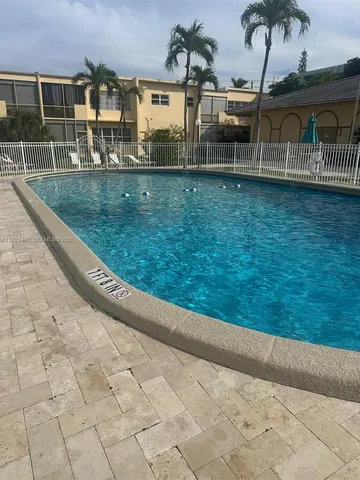 a view of yard with swimming pool and green space