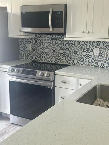 a kitchen with a stove and a microwave