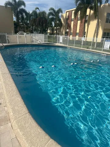 a view of a house with backyard porch and sitting area