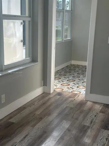 a view of kitchen and hall with wooden floor
