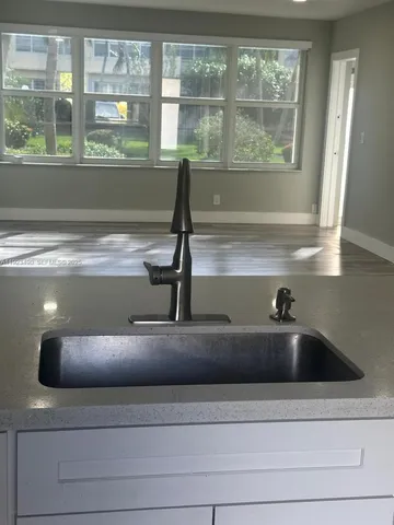 a view of a room with wooden floor and window